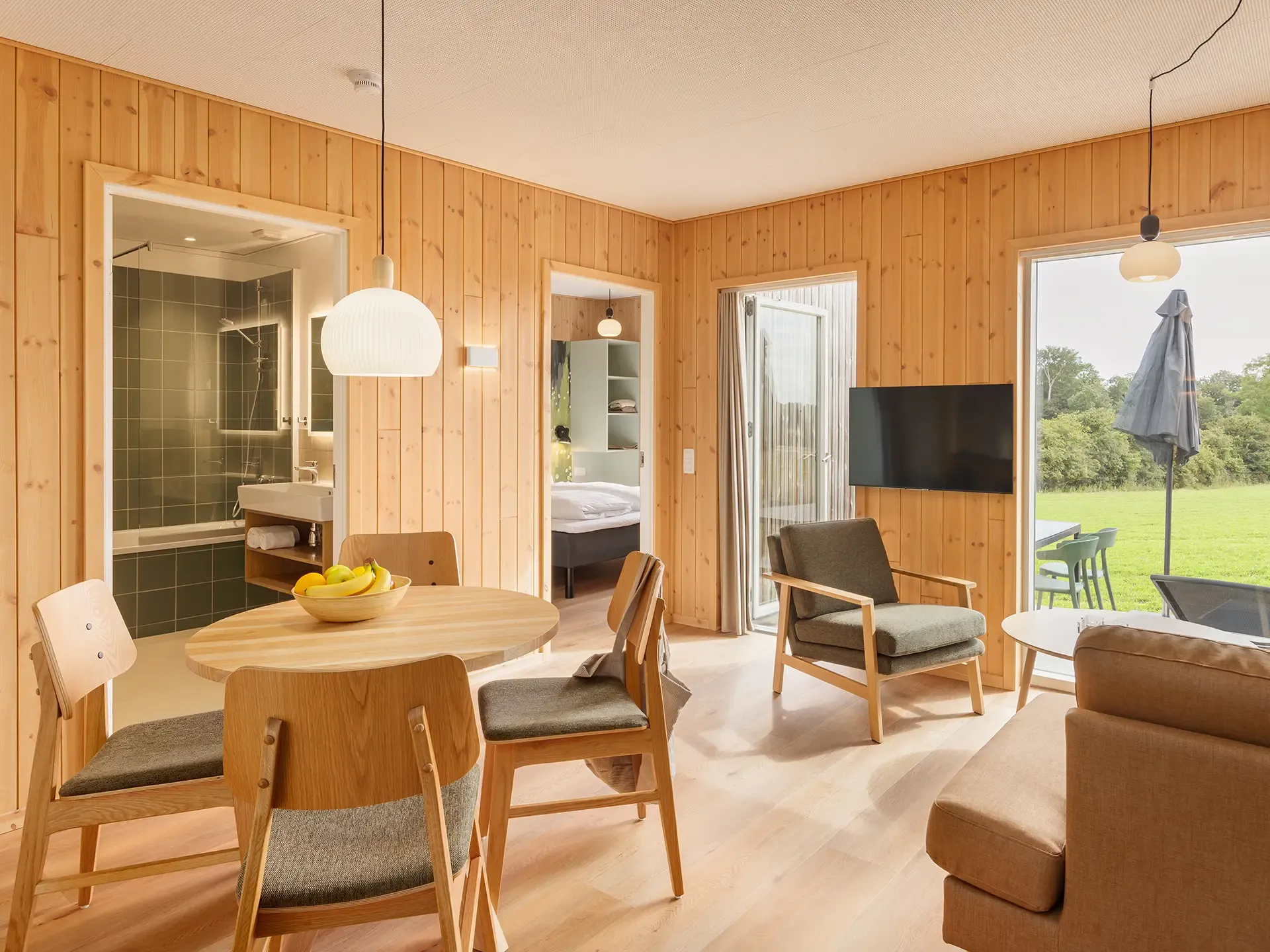 Scandinavian-inspired FF&E solution for a resort cottage living and dining space at Nordborg Resort.