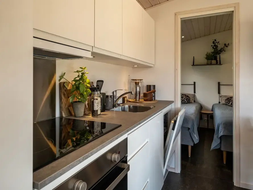 Compact cabin kitchen with smart storage and contemporary materials, designed by Third.space for Feddet Camping.